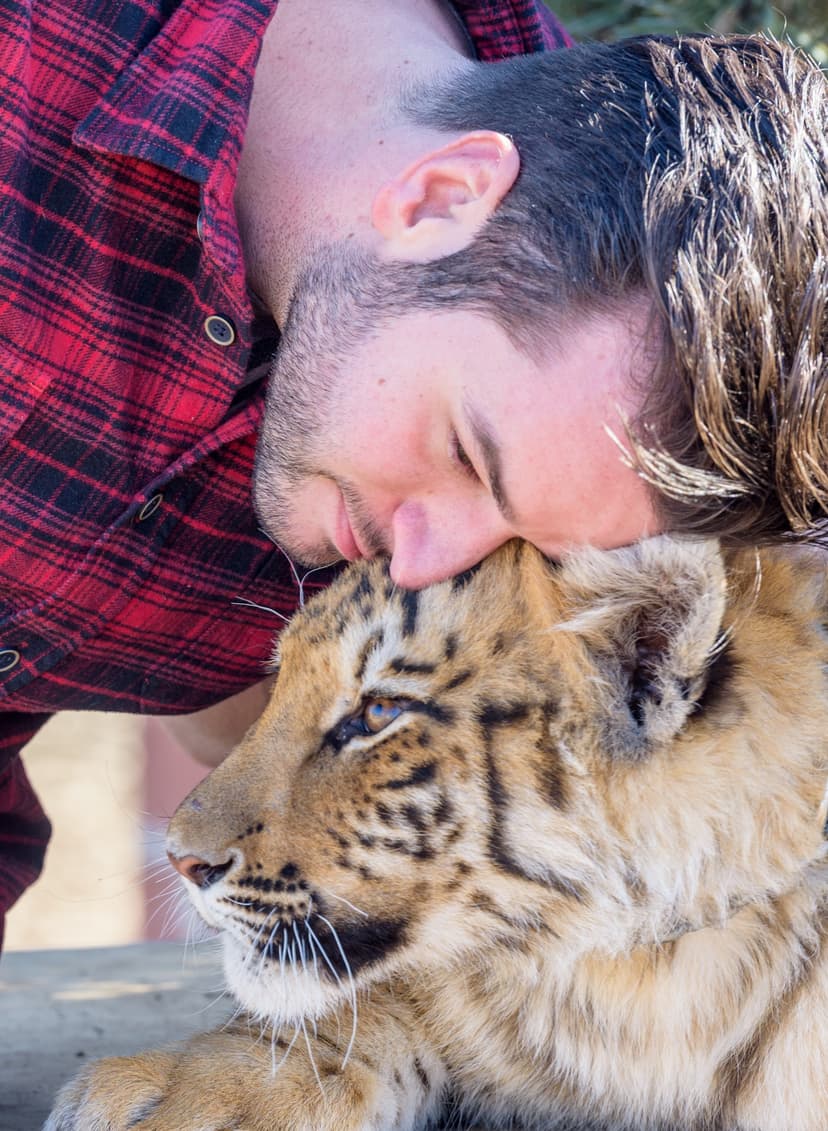 Mathias cuddling with a tiger